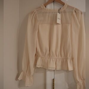 Avara’s Capri Ivory Peplum Top